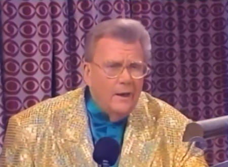 Rod is wearing a gold sequined jacket & blue collarless silk shirt