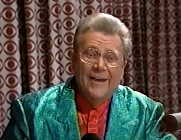 Rod is wearing a green sparkly jacket & red silk collarless shirt