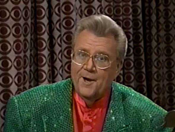 Rod is wearing a green sequined jacket & red silk collarless shirt