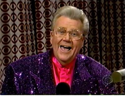 Rod is wearing a purple sequined jacket & fuchsia collarless silk shirt