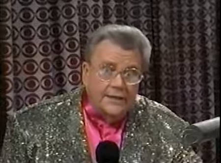 Rod is wearing a dark-gold sequined jacket & fuchsia collarless silk shirt
