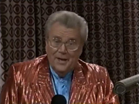 Rod is wearing a shiny dark-orange striped jacket & light-blue collarless silk shirt