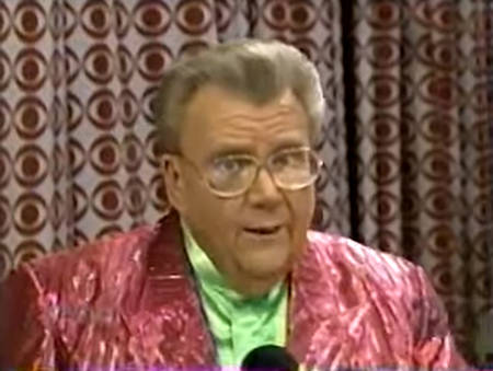 Rod is wearing a shiny pink/pink-striped jacket & lime-green collarless silk shirt