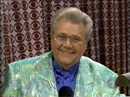 Rod is wearing a shiny mint-green striped jacket & blue collarless silk shirt