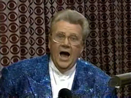 Rod is wearing a blue sequined jacket & white collarless silk shirt