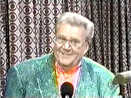 Rod is wearing a green sequined jacket & salmon collarless silk shirt