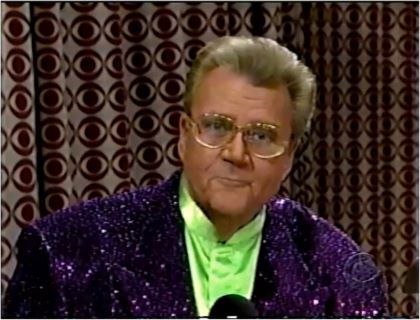 Rod is wearing a purple-sequined jacket & lime-green collarless silk shirt