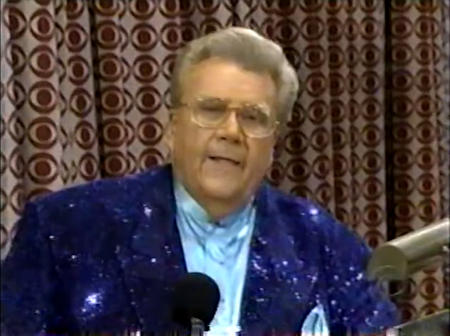 Rod is wearing a dark-blue sequined jacket & light-blue collarless silk shirt with matching pocket square