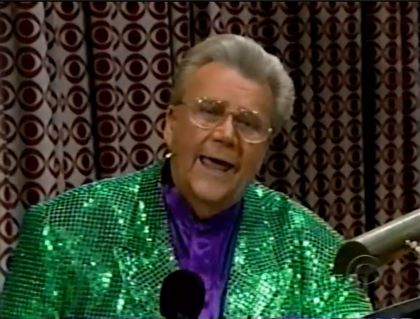Rod is wearing a green sequined jacket & purple collarless silk shirt