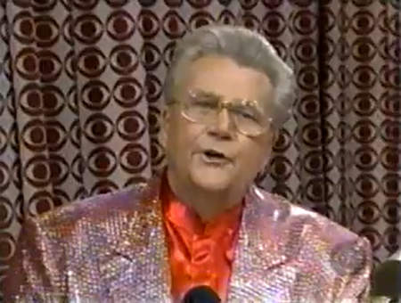 Rod is wearing a pink sequined jacket & red collarless silk shirt