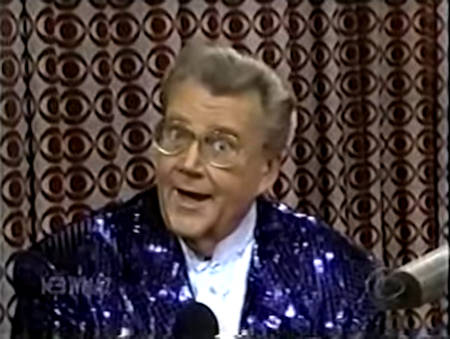 Rod is wearing a dark-blue sequined jacket & white collarless silk shirt