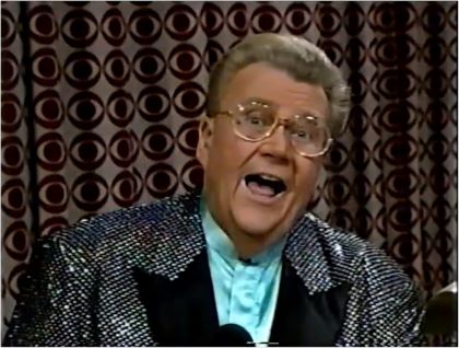 Rod is wearing a black oil-slick-sequined jacket with black lapels & light-blue collarless silk shirt