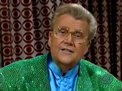 Rod is wearing a green sequined jacket & light-blue collarless silk shirt