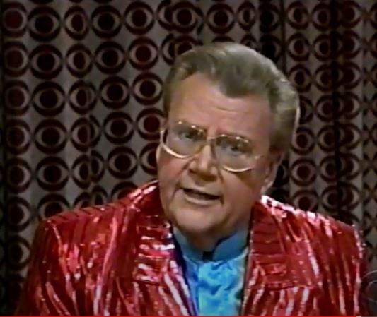 Rod is wearing a shiny red/red-striped jacket & powder blue collarless silk shirt