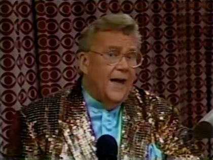 Rod is wearing a brown-sequined jacket & powder-blue collarless silk shirt w/matching pocket square