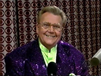 Rod is wearing a purple sequined jacket & lime-green collarless silk shirt with matching pocketsquare