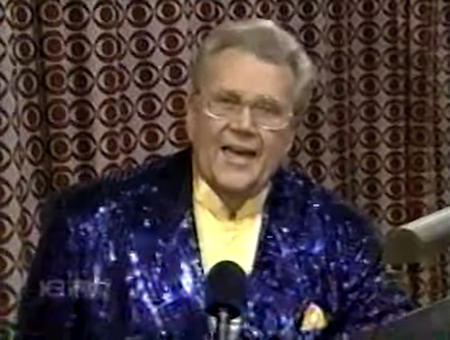 Rod is wearing a dark-blue sequined jacket & yellow collarless silk shirt with matching pocketsquare