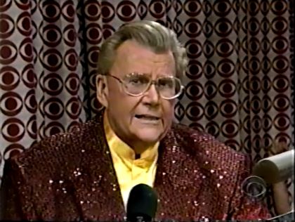 Rod is wearing a brown-sequined jacket & yellow collarless silk shirt