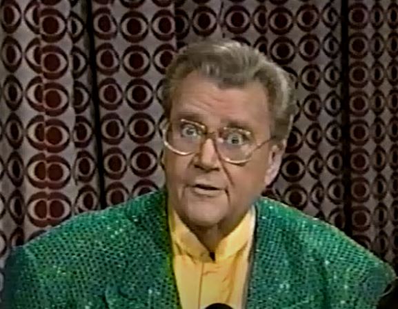 Rod is wearing a green sequined jacket & yellow collarless silk shirt