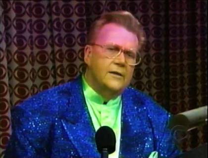 Rod is wearing a blue sequined jacket & lime-green collarless silk shirt with matching pocket square