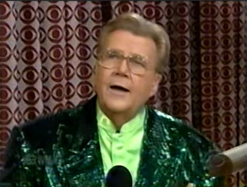 Rod is wearing a dark-green sequined jacket & lime-green collarless silk shirt
