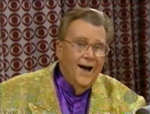 Rod is wearing a gold sequined jacket & purple collarless silk shirt
