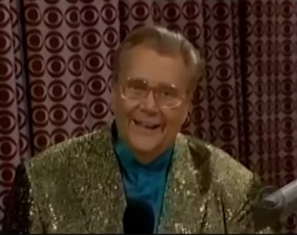 Rod is wearing a gold sequined jacket & teal collarless silk shirt