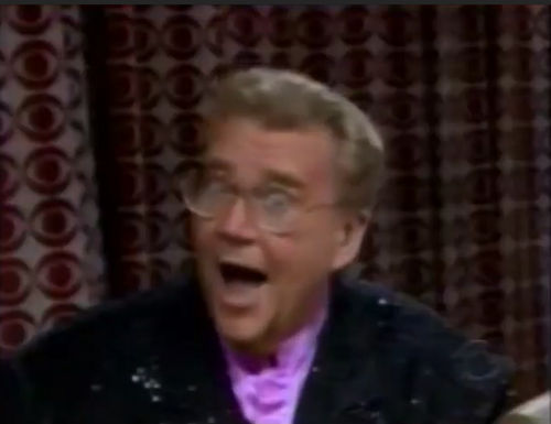Rod is wearing a black sequined jacket & violet collarless silk shirt