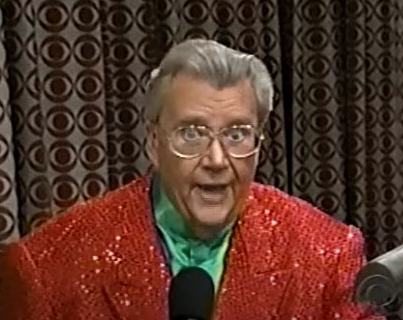 Rod is wearing a red sequined jacket & green collarless silk shirt