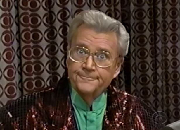 Rod is wearing a dark-red sequined jacket & green collarless silk shirt