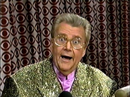 Rod is wearing a gold sequined jacket & lavender collarless silk shirt