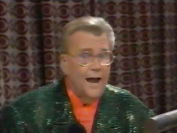 Rod is wearing a dark-green sequined jacket & salmon collarless silk shirt