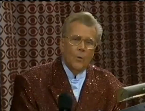 Rod is wearing a brown sequined jacket & periwinkle collarless silk shirt
