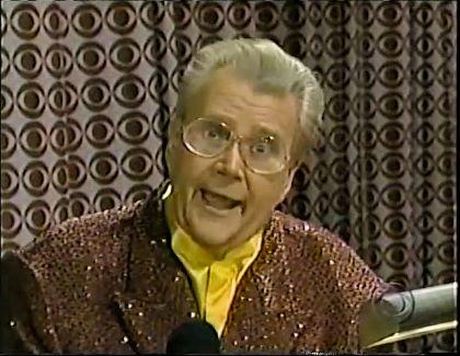 Rod is wearing a brown sequined jacket & yellow collarless silk shirt