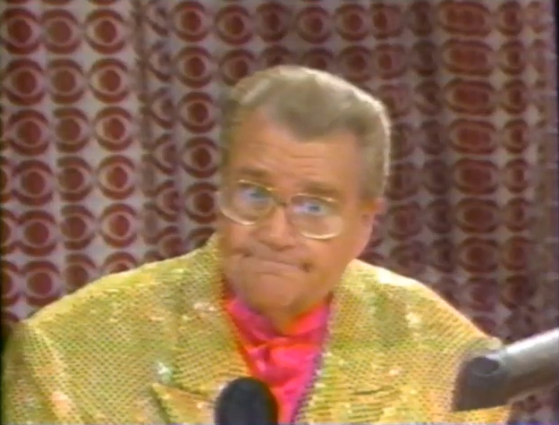 Rod is wearing a yellow sequined jacket & pink collarless silk shirt