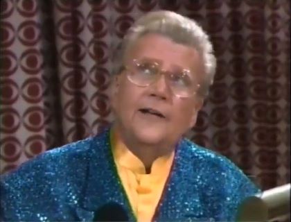 Rod is wearing a teal blue sequined jacket & yellow collarless silk shirt