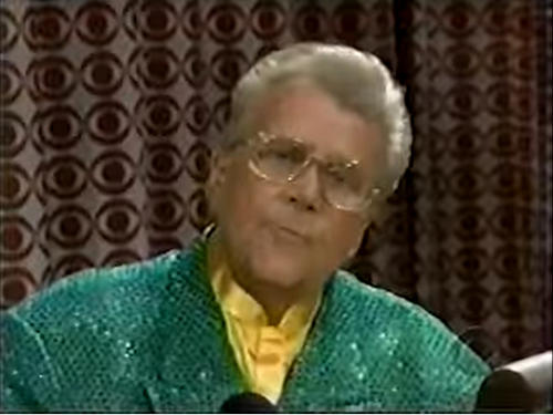 Rod is wearing a green sequined jacket & yellow collarless silk shirt