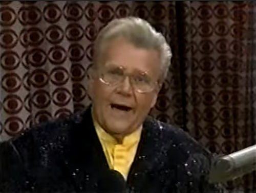 Rod is wearing a black sequined jacket & yellow collarless silk shirt