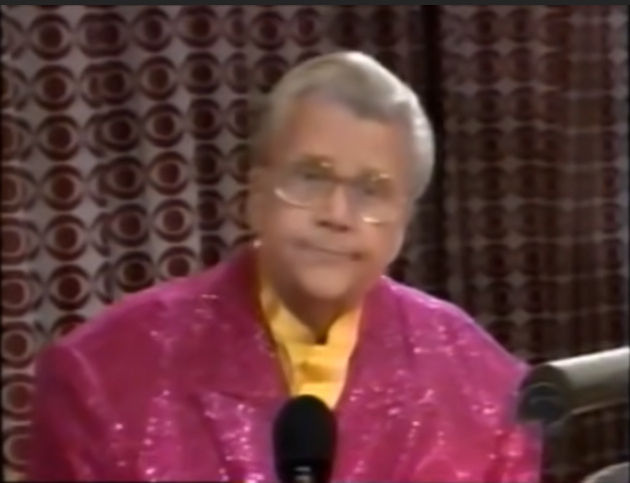 Rod is wearing a pink sequined jacket & yellow collarless silk shirt