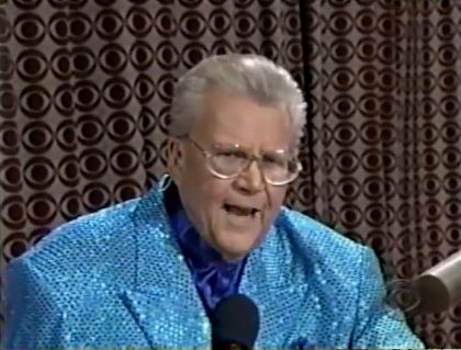 Rod is wearing a blue sequined jacket & blue collarless silk shirt