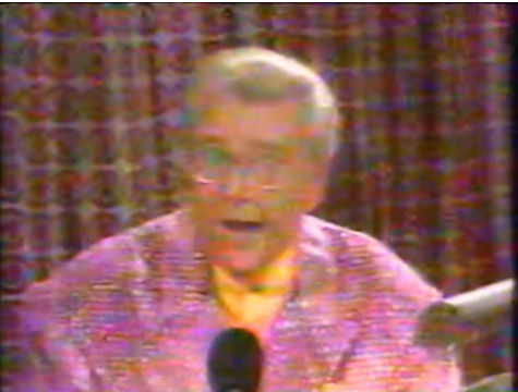 Rod is wearing a pink/purple sequined jacket & yellow collarless silk shirt