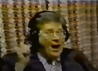 Rod is wearing a black jacket, grey shirt & mottled tie