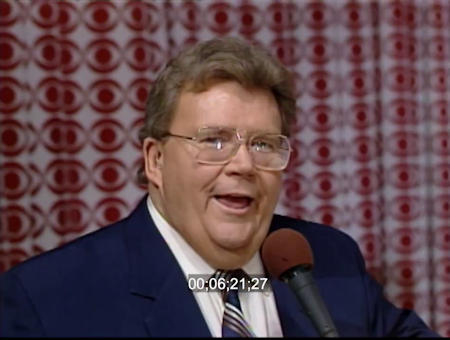 Rod is wearing a dark-blue jacket, silver-grey-white striped tie & white shirt