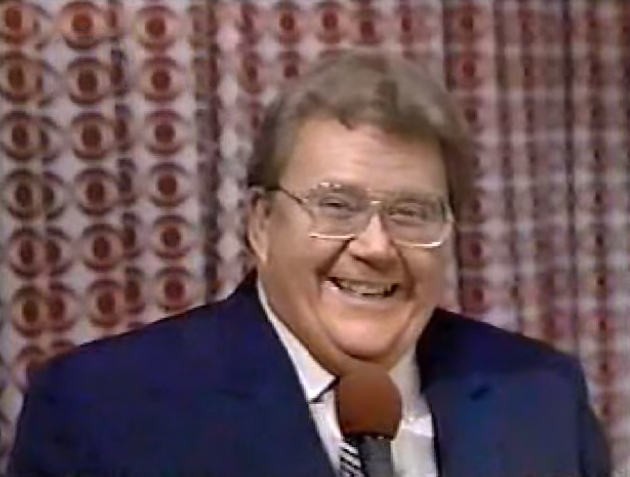 Rod is wearing a dark blue jacket, blue/white striped tie & white shirt