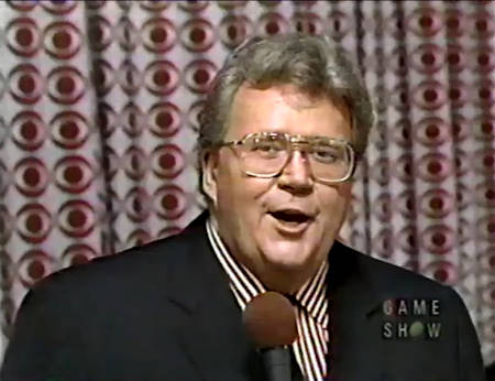 Rod is wearing a black jacket, matching necktie & red and white-striped shirt