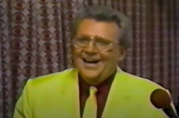 Rod is wearing a yellow jacket & tie and burgandy shirt