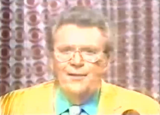 Rod is wearing a yellow/yellow-striped jacket, green shirt & yellow tie