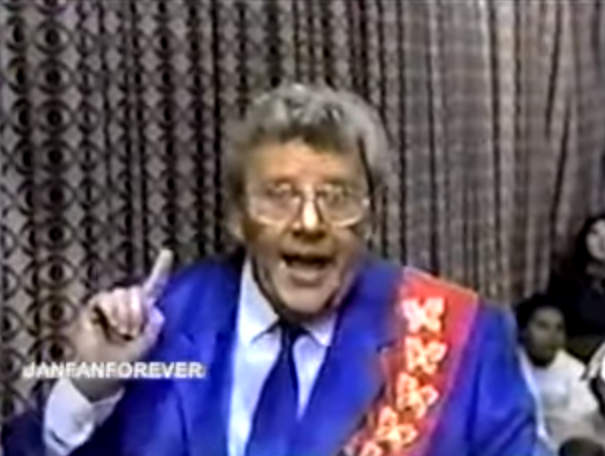 Rod is wearing a blue silk jacket, matching neck-tie, a red sash with gold butterflies & white shirt