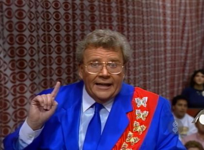 Rod is wearing a blue silk jacket, matching neck-tie, a red sash with gold butterflies & white shirt