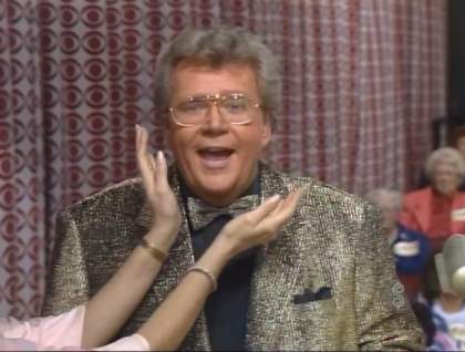 Rod is wearing a tan sequin jacket with matching bow tie and black shirt with matching pocket square